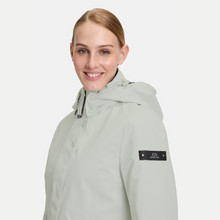 Load image into Gallery viewer, Woman wearing a light gray hooded jacket with a brand logo on a white background