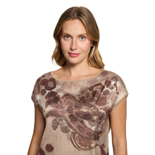 Load image into Gallery viewer, A woman wearing a short-sleeve top with a brown and beige paisley pattern, photographed against a solid white background.