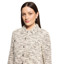 Load image into Gallery viewer, A woman wearing a textured tweed jacket in a beige and white heathered pattern with dark buttons, photographed against a solid white background.