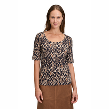 Load image into Gallery viewer, Woman wearing a leopard print top on a white background