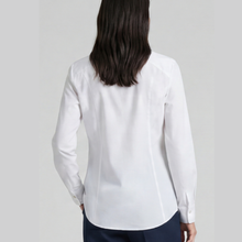 Load image into Gallery viewer, A woman viewed from the back wearing a white long-sleeve button-up blouse and dark navy pants, set against a plain light gray studio background.