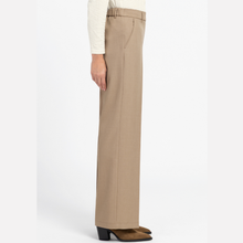 Load image into Gallery viewer, A side view of a person wearing high-waisted, wide-leg taupe pants, a cream striped long-sleeve top, and brown suede boots against a plain white studio background.