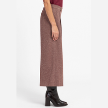 Load image into Gallery viewer, A side-profile view of a model wearing a high-waisted, wide-leg cropped skirt in a textured dusty rose-brown tweed fabric, paired with black ankle boots against a plain white studio background.