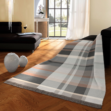 Load image into Gallery viewer, Plaid blanket on a wooden floor in a living room setting