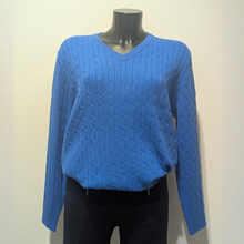 Load image into Gallery viewer, Front of Castle Sea Spirit cable Vee Neck Jumper, in blue, with a cream background.