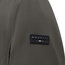 Load image into Gallery viewer, Close-up of a dark olive green jacket sleeve featuring a black rectangular Bugatti logo patch on the upper arm.