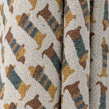 Load image into Gallery viewer, Textile with dog pattern in brown, blue, and yellow on a beige background