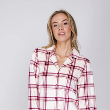 Load image into Gallery viewer, A woman wearing a long-sleeve button-up shirt with a red and white plaid pattern, photographed against a solid light gray background.