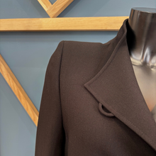 Load image into Gallery viewer, Black coat on a mannequin against a geometric wall design