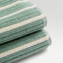 Load image into Gallery viewer, Stack of green and white striped towels on a light gray background