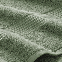 Load image into Gallery viewer, Close-up of a green textured fabric