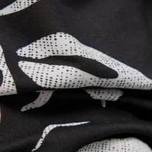 Load image into Gallery viewer, Close-up of black fabric with white abstract patterns