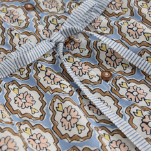 Load image into Gallery viewer, Close-up of a fabric with a floral pattern and striped trim.