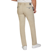 Load image into Gallery viewer, Beige pants worn by a person on a white background