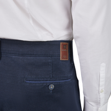 Load image into Gallery viewer, Navy pants with a brand label on a white background