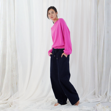 Load image into Gallery viewer, Woman in pink sweater and black trousers on white background
