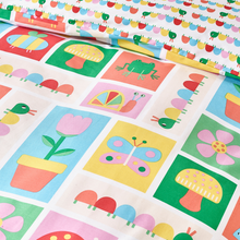 Load image into Gallery viewer, Children's fabric with colorful patterns of animals, plants, and shapes on a white background.