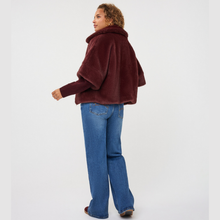 Load image into Gallery viewer, Rear of model on poncho on model with jeans
