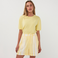 Load image into Gallery viewer, Woman wearing a yellow top and striped skirt on a white background