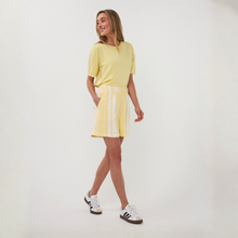 Load image into Gallery viewer, Woman wearing a yellow outfit with a white background