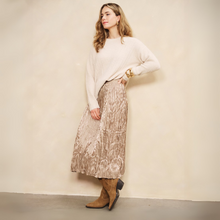 Load image into Gallery viewer, Woman wearing a white sweater and patterned skirt against a plain background