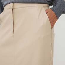 Load image into Gallery viewer, Close-up of beige pants with a person wearing them on a light background
