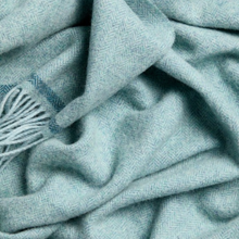 Load image into Gallery viewer, Close-up of a textured teal fabric with a tassel