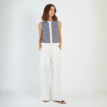 Load image into Gallery viewer, Woman wearing a sleeveless striped top and white pants on a plain background