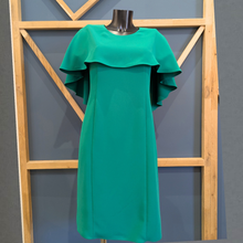 Load image into Gallery viewer, Green dress on a mannequin against a wooden geometric frame and gray wall.