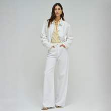 Load image into Gallery viewer, Woman wearing a white outfit with a yellow top against a plain background