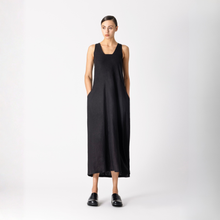 Load image into Gallery viewer, Woman wearing a black sleeveless dress on a white background