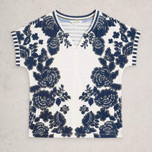 Load image into Gallery viewer, White shirt with blue floral pattern on a gray background