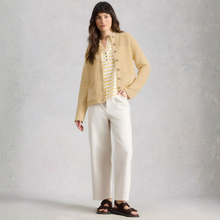 Load image into Gallery viewer, Model wearing White Stuff Gigi Washed Cardi in light yellow, with a light grey background.