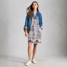 Load image into Gallery viewer, Woman wearing a patterned dress with a denim jacket on a plain background