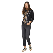 Load image into Gallery viewer, Woman wearing a black jacket with a patterned design, dark jeans, and white sneakers on a white background