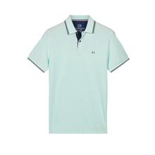 Load image into Gallery viewer, Light blue polo shirt with brand logo on a white background