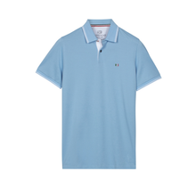 Load image into Gallery viewer, Light blue polo shirt with brand logo on a white background