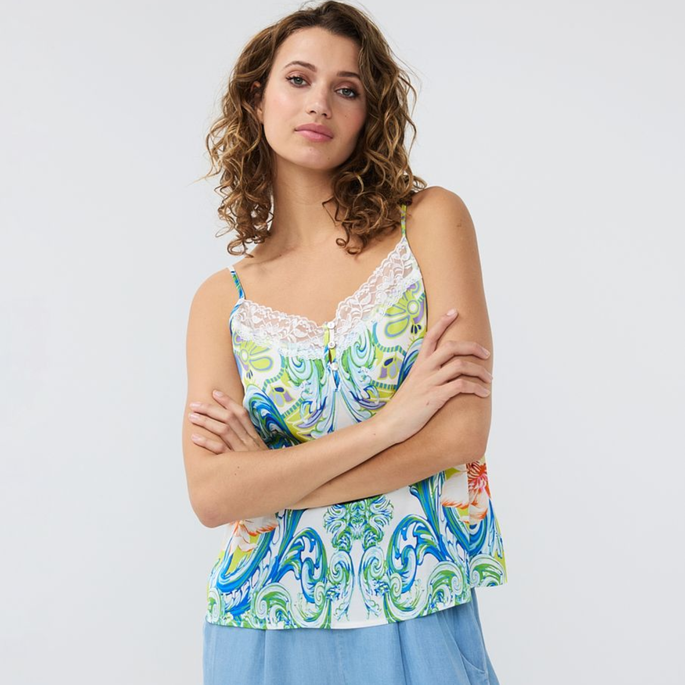 female model wearing esqualo camisole top in print colour with arms folded looking at camera