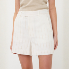 Load image into Gallery viewer, White pleated skirt worn by a person on a plain background