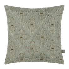 Load image into Gallery viewer, A square decorative throw pillow in a muted sage green color, featuring an intricate raised floral lace pattern in a lighter cream-beige thread. Small metallic gold buttons are scattered across the surface, and a small brand tag for 'The Toy' is visible on the bottom right edge.