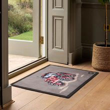 Load image into Gallery viewer, Decorative doormat with a tractor design on a wooden floor in front of a door.