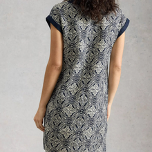 Load image into Gallery viewer, Woman wearing a black and white patterned dress against a gray background