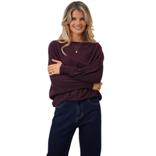 Load image into Gallery viewer, Woman wearing a purple sweater and blue jeans on a white background