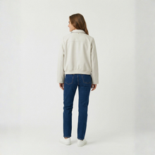 Load image into Gallery viewer, Person wearing a light-colored jacket and blue jeans on a white background