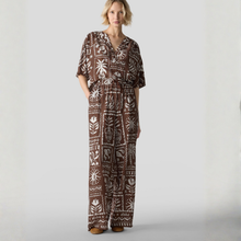 Load image into Gallery viewer, Woman wearing a brown patterned jumpsuit on a white background