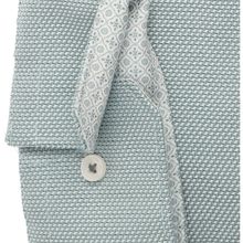 Load image into Gallery viewer, Close-up of a light blue and white patterned shirt fabric with a button and a patterned necktie, showing the texture and design details.