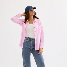 Load image into Gallery viewer, Woman wearing a pink striped shirt, white top, and blue jeans on a light gray background