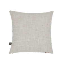Load image into Gallery viewer, A square throw pillow made of natural beige linen fabric, featuring a small black brand tag on the lower left edge, set against a plain white background.