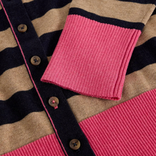 Load image into Gallery viewer, Close-up of a striped knit cardigan with beige and dark navy horizontal stripes, bright pink ribbed trim, and brown buttons.