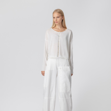 Load image into Gallery viewer, Woman wearing a white dress against a plain background